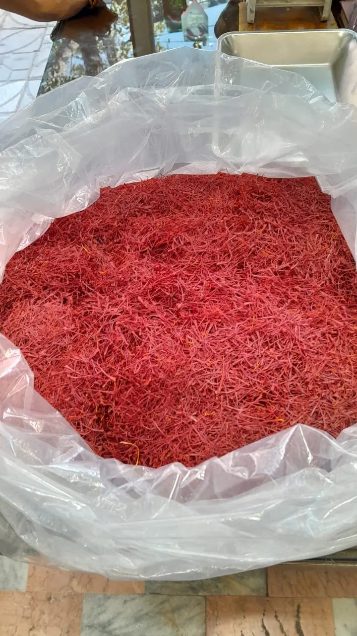 An open bulk bag filled with red saffron threads