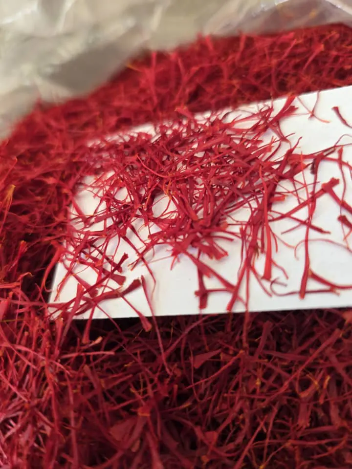 Saffron threads spread on a white card for grading