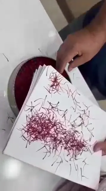 Threads separated on white sheets during a manual quality check