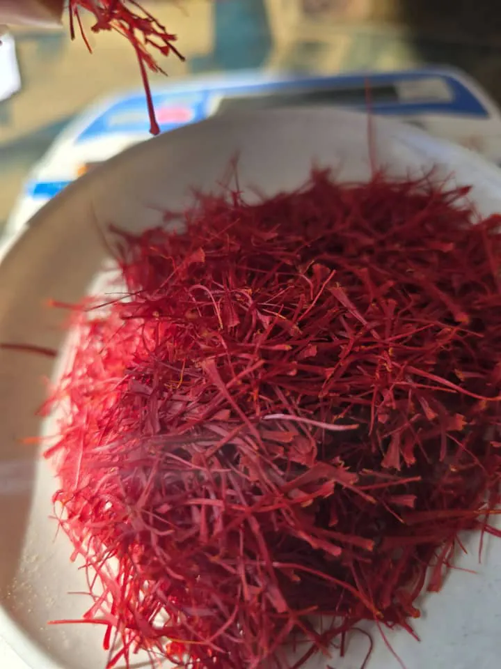 Close-up of deep red Super Negin saffron threads in a white bowl