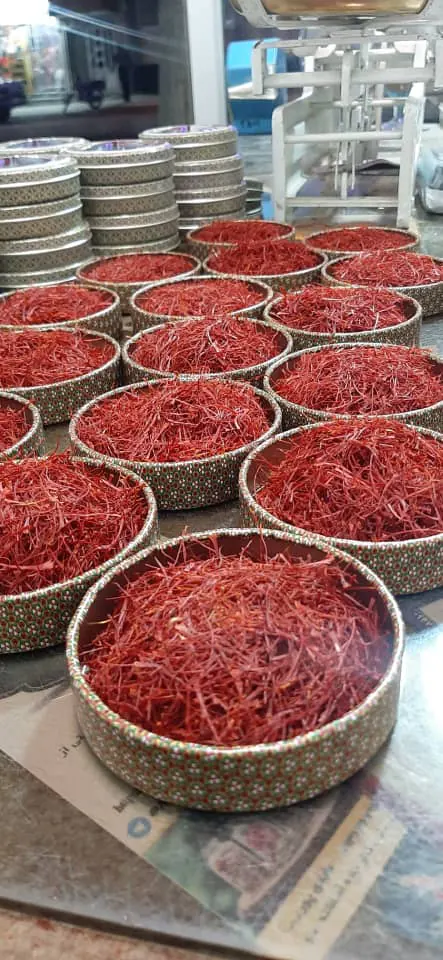 Open tins of saffron ready for packing